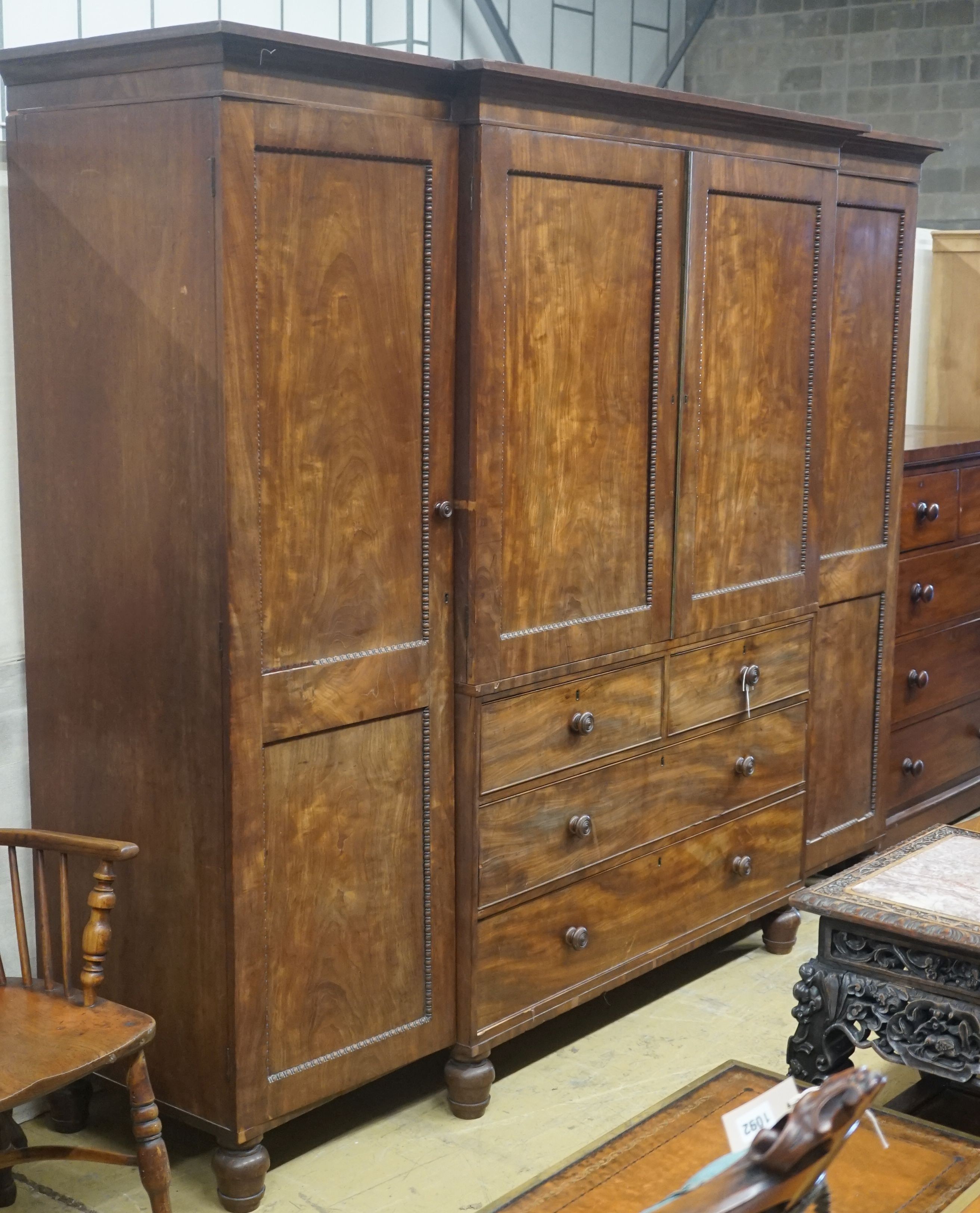 A George IV flamed mahogany break-front wardrobe, length 244cm, depth 60cm, height 195cm